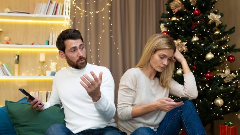 Young family couple quarreled over mobile phone and social networks, man and woman sad during the